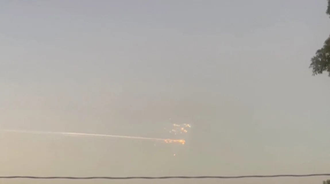 A streak of light across the sky with a collection of bright dots at the right-hand end of it.